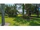 Lush landscaping with mature trees and green grass at 4440 Calle Serena, Sarasota, FL 34238