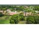 Aerial view showcasing a villa community near a golf course and pond at 4440 Calle Serena, Sarasota, FL 34238