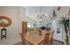 Elegant dining area with a wooden table, chandelier, and access to the living room at 4440 Calle Serena, Sarasota, FL 34238