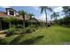 Row of villas with lush landscaping and a green lawn at 4440 Calle Serena, Sarasota, FL 34238