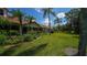 Row of villas with lush landscaping and a green lawn at 4440 Calle Serena, Sarasota, FL 34238