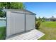 White metal storage shed with wood deck overlooking a lake at 1255 Lincoln Dr, Englewood, FL 34224