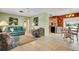 Open living space with teal couch, dining area, and kitchen views at 1255 Lincoln Dr, Englewood, FL 34224
