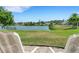 Peaceful backyard oasis with lake view and seating area at 1255 Lincoln Dr, Englewood, FL 34224