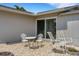 Small patio with white metal table and chairs at 1255 Lincoln Dr, Englewood, FL 34224