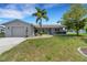 Single-story home with attached garage and landscaped front yard at 1255 Lincoln Dr, Englewood, FL 34224