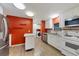 Bright kitchen with white cabinets, stainless steel appliances, and orange accent wall at 1508 45Th E Ave, Ellenton, FL 34222
