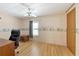 Bedroom with wood flooring, ceiling fan, and coastal-themed wallpaper at 1508 45Th E Ave, Ellenton, FL 34222