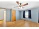Bedroom with light blue walls, wood flooring and ceiling fan at 1508 45Th E Ave, Ellenton, FL 34222