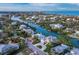 Aerial view of waterfront community featuring beautiful homes nestled among lush greenery and canals, highlighting coastal charm at 3550 Flamingo Ave, Sarasota, FL 34242