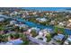 Expansive aerial view of waterfront properties, showcasing a desirable coastal community with lush landscaping and serene waterways at 3550 Flamingo Ave, Sarasota, FL 34242