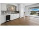 A sleek bar area features a beverage fridge, sink, and elegant tile backsplash that complements the light-filled space at 3550 Flamingo Ave, Sarasota, FL 34242