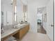 Elegant bathroom featuring double vanities, stone countertops, and access to the bedroom creating a peaceful and functional space at 3550 Flamingo Ave, Sarasota, FL 34242