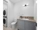 Bathroom with marble countertop, toilet, washer, and dryer in a modern setting at 3550 Flamingo Ave, Sarasota, FL 34242