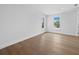 Bright and airy bedroom with hardwood floors and two windows offering a serene view at 3550 Flamingo Ave, Sarasota, FL 34242