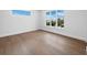 Bright bedroom with hardwood floors and large windows offering serene views at 3550 Flamingo Ave, Sarasota, FL 34242