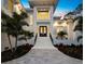 Elegant home entrance featuring double doors, white stucco and landscaped surroundings at 3550 Flamingo Ave, Sarasota, FL 34242