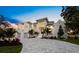 Elegant two-story home with white stucco exterior, paved driveway, lush landscaping, and attached two-car garage at 3550 Flamingo Ave, Sarasota, FL 34242