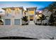 Beautiful two-story home featuring white exterior, multiple windows, two-car garage, and elegant driveway at 3550 Flamingo Ave, Sarasota, FL 34242