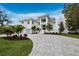 Charming two-story home boasts a lush landscaped yard with a paver driveway leading to the residence at 3550 Flamingo Ave, Sarasota, FL 34242