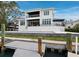 A modern waterfront home showcases a private dock and pool, seamlessly blending luxury with outdoor living and entertaining at 3550 Flamingo Ave, Sarasota, FL 34242