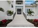 Inviting front entrance with stairs and iron railings that lead to double doors at 3550 Flamingo Ave, Sarasota, FL 34242