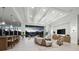 Open-concept living area with coffered ceilings and a large sliding glass door to a balcony overlooking the water at 3550 Flamingo Ave, Sarasota, FL 34242