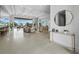 Bright, open-concept living room with tile floors, stylish furniture, and waterfront views at 3550 Flamingo Ave, Sarasota, FL 34242