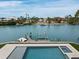 Aerial view of a waterfront home with a pool, boat dock, and boat lift at 3550 Flamingo Ave, Sarasota, FL 34242
