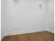 Bright, versatile room with light hardwood flooring and two windows, ideal for a home office or spare bedroom at 3550 Flamingo Ave, Sarasota, FL 34242