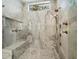 Modern walk-in shower with rainfall showerhead, bench seating, and luxurious tile work, creating a spa-like experience at home at 3550 Flamingo Ave, Sarasota, FL 34242