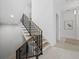 Elegant staircase featuring wood steps, black railings, and bright white walls, creating a modern aesthetic at 3550 Flamingo Ave, Sarasota, FL 34242