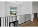 Modern staircase featuring a large window with a view, black railings, and wooden floors at 3550 Flamingo Ave, Sarasota, FL 34242