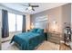 Comfortable bedroom with a teal comforter and plenty of natural light at 4138 Central Sarasota Pkwy # 1534, Sarasota, FL 34238