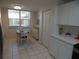 Bright eat-in kitchen area with window view, tile floors, white cabinets, and closet storage at 5230 Hyland Hills Ave # 1315, Sarasota, FL 34241