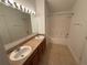 Bathroom with dual sinks, large mirror, and shower/tub combo, perfect for relaxation at 14812 Skip Jack Loop, Lakewood Ranch, FL 34202