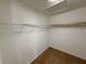 Walk-in closet providing ample storage with white wire shelving and a cozy carpeted floor at 14812 Skip Jack Loop, Lakewood Ranch, FL 34202
