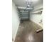 Attached garage with an automatic door, overhead lighting, and built-in shelves for convenient storage at 14812 Skip Jack Loop, Lakewood Ranch, FL 34202