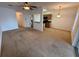 Spacious living room adjacent to kitchen featuring stainless steel appliances and open layout at 14812 Skip Jack Loop, Lakewood Ranch, FL 34202