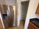Next to a stainless refrigerator is a nice-sized pantry, perfect for storage and organization at 14812 Skip Jack Loop, Lakewood Ranch, FL 34202
