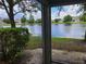 Relaxing lake view from screened patio, showcasing peaceful neighborhood setting at 14812 Skip Jack Loop, Lakewood Ranch, FL 34202