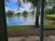 Screened patio overlooking a serene lake with lush greenery at 14812 Skip Jack Loop, Lakewood Ranch, FL 34202