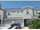 Two-story light blue townhome with two-car garage and lush landscaping at 14812 Skip Jack Loop, Lakewood Ranch, FL 34202