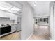 Light hallway with wood-look floors leads to living room and kitchen at 6038 Lilli Way # 6038, Bradenton, FL 34207