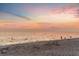Tranquil beach scene at sunset with people enjoying the water at 6038 Lilli Way # 6038, Bradenton, FL 34207