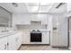 Bright kitchen features white cabinets, stove, and refrigerator at 6038 Lilli Way # 6038, Bradenton, FL 34207