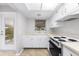 Efficient kitchen with white cabinetry and a four-burner stove at 6038 Lilli Way # 6038, Bradenton, FL 34207
