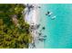 Aerial view of a pristine beach with crystal-clear water and lush greenery at 6038 Lilli Way # 6038, Bradenton, FL 34207