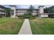 Two-story building with landscaped grounds at 6507 Stone River Rd # 302, Bradenton, FL 34203