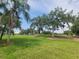 Expansive grassy area with mature trees, providing a serene outdoor setting at 6507 Stone River Rd # 302, Bradenton, FL 34203